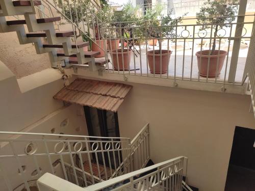 a set of stairs with potted plants on them at Loggia Traditional Suites in Rethymno Town