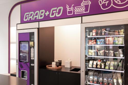 a grocery store with a soda vending machine at YOTEL Porto in Porto