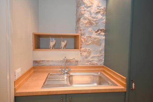 a kitchen with a sink and a wooden counter top at Carpe Diem Moursia Studio in Liapades