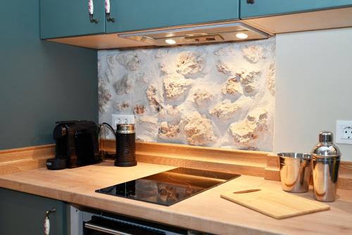 a kitchen with a counter top with a stove top oven at Carpe Diem Moursia Studio in Liapades
