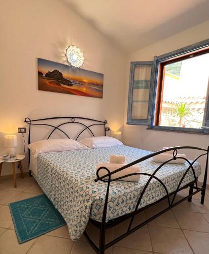 a bedroom with a bed and a window at Sa Terrazza costarei in Costa Rei