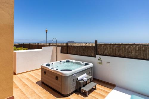 a jacuzzi tub on the balcony of a house at Villa Leonor - Mirador de las Dunas in Corralejo