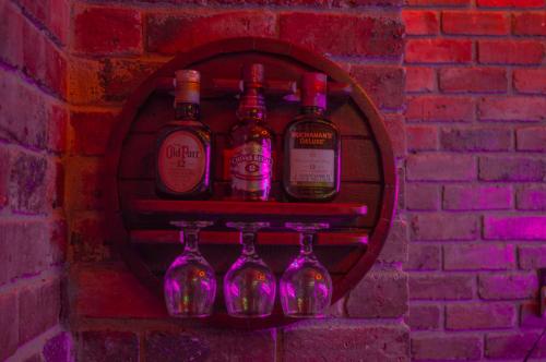 a group of wine bottles on a brick wall at El Nogal finca-hotel in Firavitoba