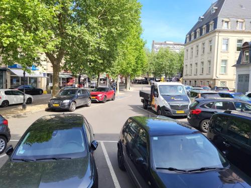 a bunch of cars parked on a city street at Guesthaus 2 in Dudelange