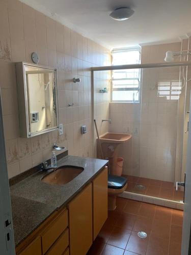 a bathroom with a sink and a toilet and a mirror at Rub-a-Dub in Santos