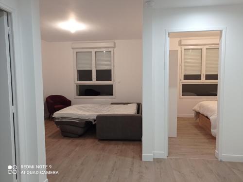 Ένα ή περισσότερα κρεβάτια σε δωμάτιο στο AppartHôtel