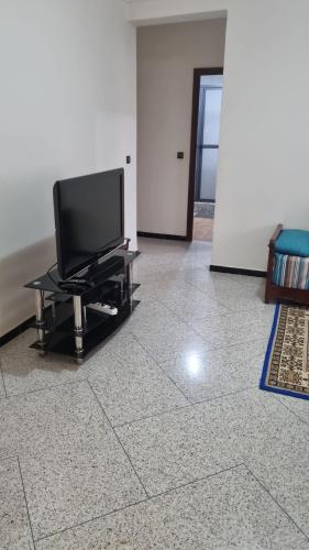 uma televisão de ecrã plano sentada numa mesa numa sala de estar em appartement centre kenitra em Kenitra