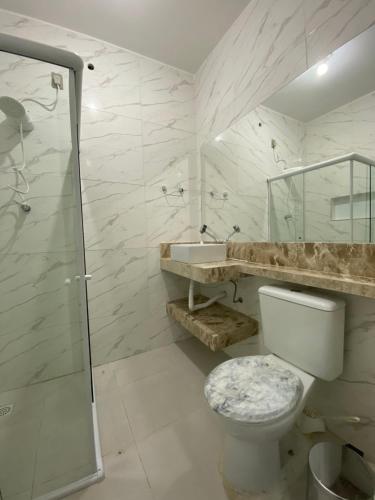 a bathroom with a shower and a toilet and a sink at Pousada Sertaneja in Canindé de São Francisco