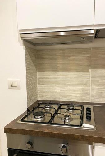 a kitchen with a stove top in a kitchen at La Casa di LEO - Apartments in Recanati