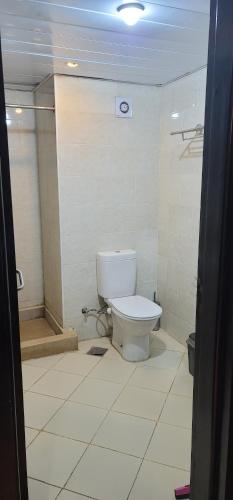 a bathroom with a toilet in a room at شاليه فندقي ببورتو مارينا in El Alamein