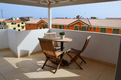 a patio with a table and chairs on a balcony at Branco Suites - Rooms & Holiday Apartments in Santa Maria