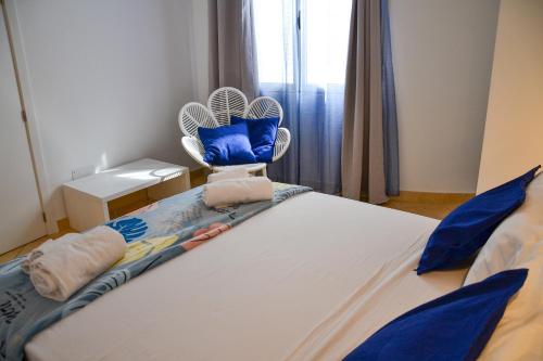 a bedroom with a bed with a fan on it at Branco Suites - Rooms & Holiday Apartments in Santa Maria