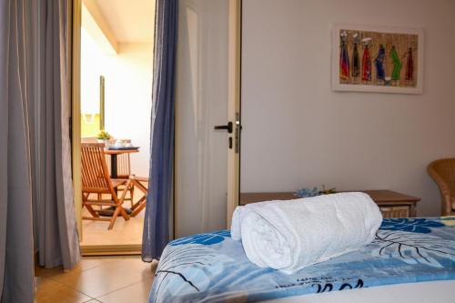 a bedroom with a bed with towels on it at Branco Suites - Rooms & Holiday Apartments in Santa Maria