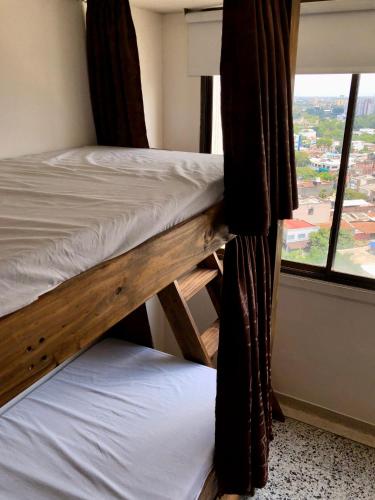 two bunk beds in a room with a window at Mae's Skate House in Cali