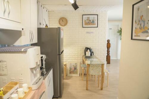 a kitchen with a refrigerator and a table at House Mongja in Seoul