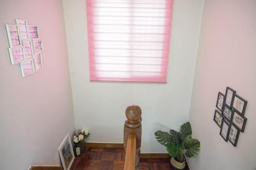 a room with a pink window and a wooden floor at House Mongja in Seoul