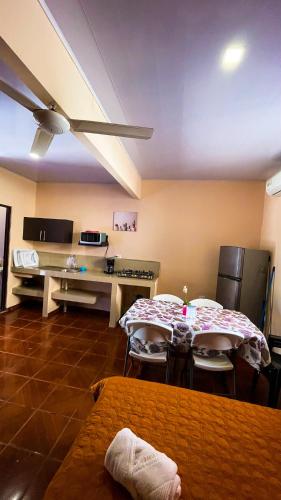 a room with a table and chairs and a kitchen at Hotel Beachfront Vista Hermosa in Jacó