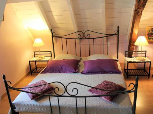 a bedroom with a metal bed with purple pillows at Maison à Lamonzie-Saint-Martin avec Piscine et Animaux admis - FR-1-616-112 in Lamonzie-Saint-Martin