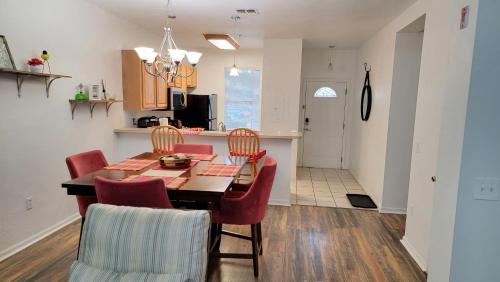 a kitchen and dining room with a table and chairs at 2 Master Suite Apartment near North Florida Regional Med, UF Health, & Mall in Gainesville