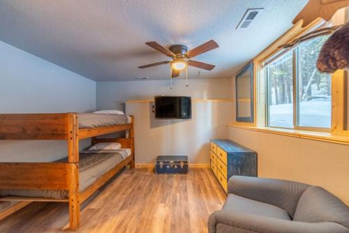 a bedroom with bunk beds and a ceiling fan at Beautiful New Construction Home with Great Views and Pool Table - Silverheels Chalet in Fairplay