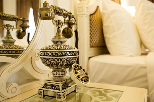 a vase sitting on top of a glass table at Eldora Hotel in Hue