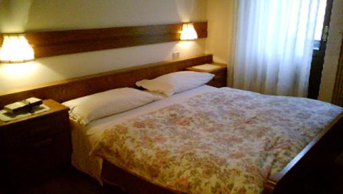 a bedroom with a large bed with two pillows at Campiglio Trilocale Monte Spinale in Madonna di Campiglio