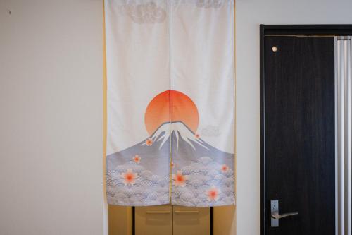 a curtain with a mountain and a sunset at Holiday home Furinkazan 風林火山 in Fujikawaguchiko