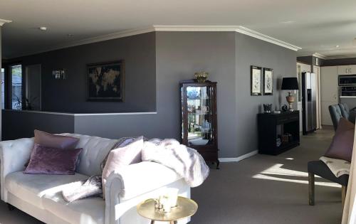 a living room with a couch and a table at KARANDA BnB in Rotorua