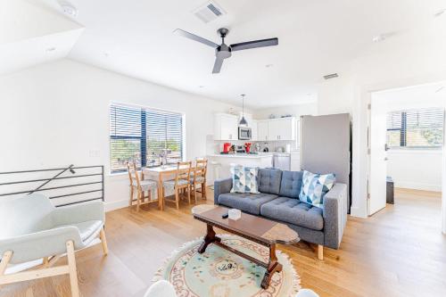 a living room with a couch and a table at Luxe East Downtown 3BR Condo, Walk to Bars, Restaurants, Shops in Austin