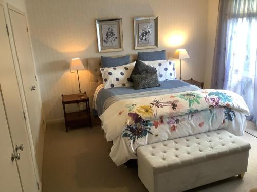 a bedroom with a large bed with a floral bedspread at KARANDA BnB in Rotorua