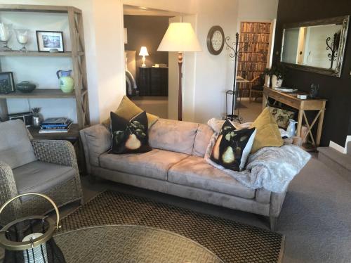 a living room with a couch and a chair at KARANDA BnB in Rotorua