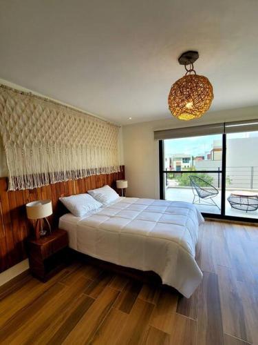 a bedroom with a large bed and a large window at Amazing Dream Home in Gated Community in Playa del Carmen