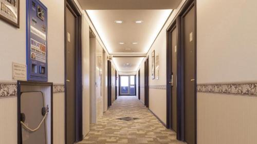 a hallway in a building with a long corridor at Toyoko Inn Tokyo Seibu Ikebukuro sen Higashi kurume eki Nishi guchi in Higashikurume