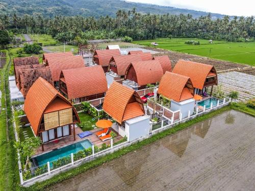an overhead view of a row of houses with orange roofs at Bhumi Lovina Residence & Villa in Singaraja