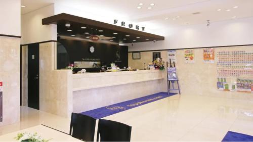 a restaurant with a counter in the middle of a room at Toyoko Inn Tokyo Fussa Ekimae Higashi guchi in Fussa