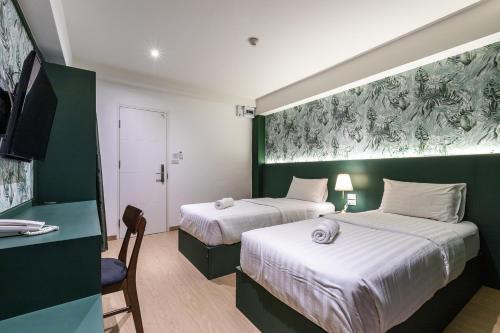 Postel nebo postele na pokoji v ubytování Siam Star Hotel