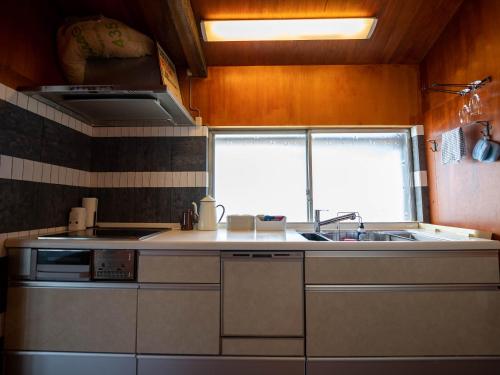 A kitchen or kitchenette at SUMITSUGU HOUSE West