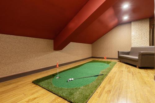 a golf course in a room with a couch at ホテル チャペルココナッツ 亀山 in Kameyama