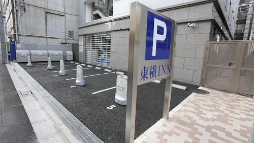 a parking lot with a parking sign in front of a building at Toyoko Inn Tokyo Hachioji-eki Kita-guchi in Hachioji