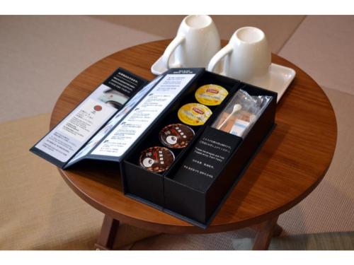 a table with a box of donuts on it at Hotel Meldia Shijo Kawaramachi - Vacation STAY 86747 in Kyoto