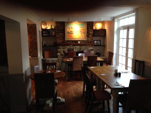 a restaurant with tables and chairs in a room at The Crown Inn, Kemerton in Tewkesbury