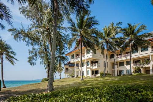 an exterior view of a resort with palm trees at SAii Laguna Phuket in Bang Tao Beach