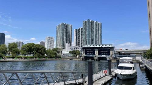 a boat docked at a dock in a river with buildings at Toyoko Inn Tokyo Shinagawa Konan-guchi Tennozu Isle in Tokyo