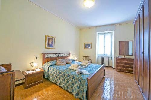 a bedroom with a bed with a blue comforter at Casa Angela -beautiful View lake - Happy Rentals in Toscolano Maderno