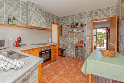 a kitchen with a sink and a counter top at Racó Blau in Cap d'en Font
