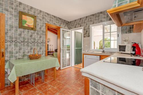 a kitchen with a sink and a counter top at Racó Blau in Cap d'en Font