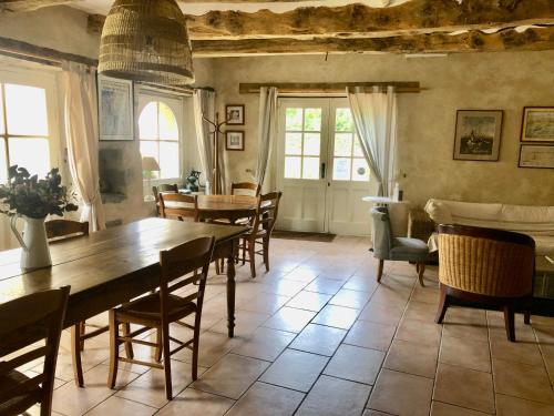 une salle à manger avec une table et des chaises dans l'établissement La Chaumière de la Chaize, à Saint-Jouan-des-Guérets