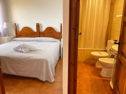 a bedroom with a bed and a bathroom with a toilet at Wonderful Apartment with Outstanding Views - Calella de Palfrugell in Calella de Palafrugell
