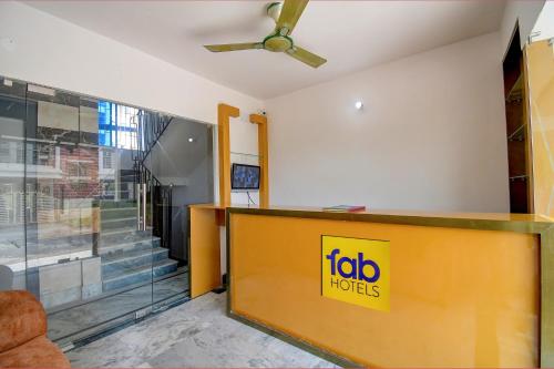 a office with a yellow sign on the wall at FabExpress Amar Raj Villa in Kolkata