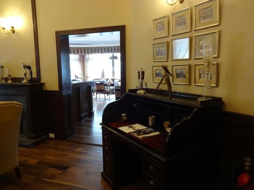 a living room with a piano and a mirror at The Claridges Nabha Residence in Mussoorie